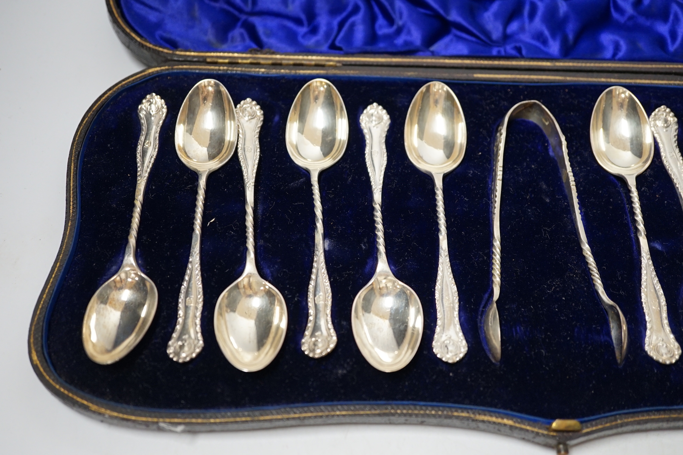 A cased set of twelve late Victorian silver teaspoons with tongs, William Hutton & Sons, London, 1898, a late Victorian silver lighthouse sugar caster, London, 1889, five assorted silver napkin rings and a silver mounted